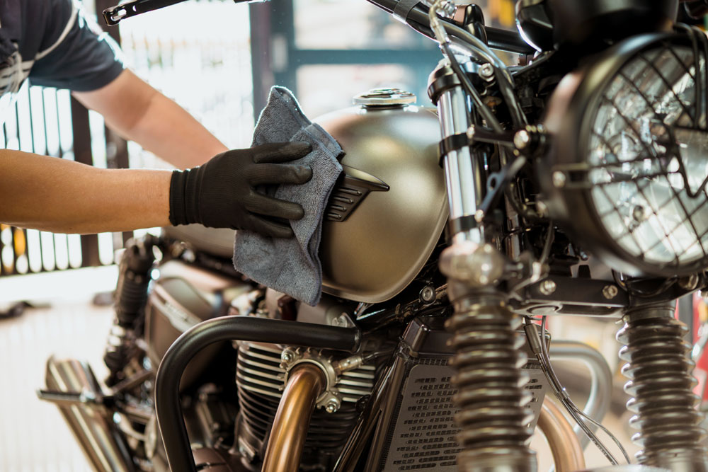 Biker-man-cleaning-motorcycle